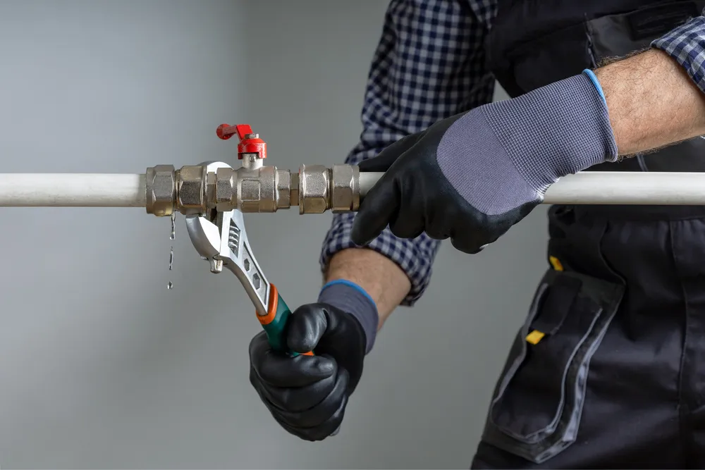 Wrench tightening a pipe fitting during a repair — illustrative stock photo, not an actual Pahrump job site