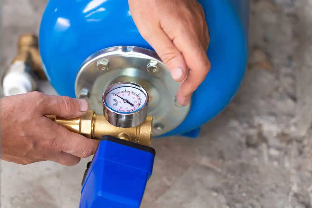 Pressure tank and valve assembly being installed — illustrative stock photo of a pressure tank installation, not an actual Pahrump job site
